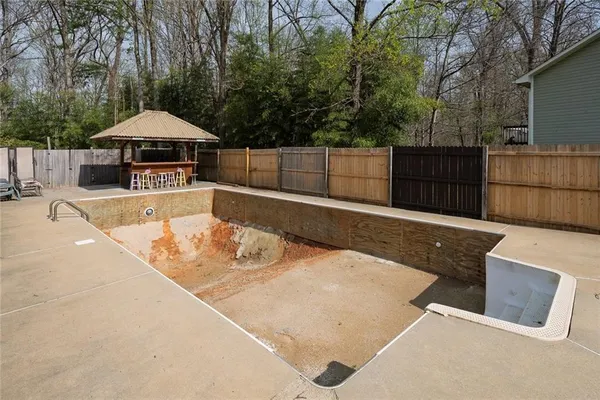 a view of a backyard with a wooden fence