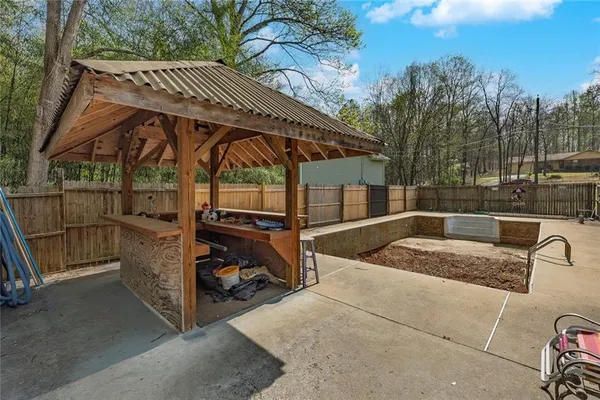 a view of outdoor space with wooden fence and trees