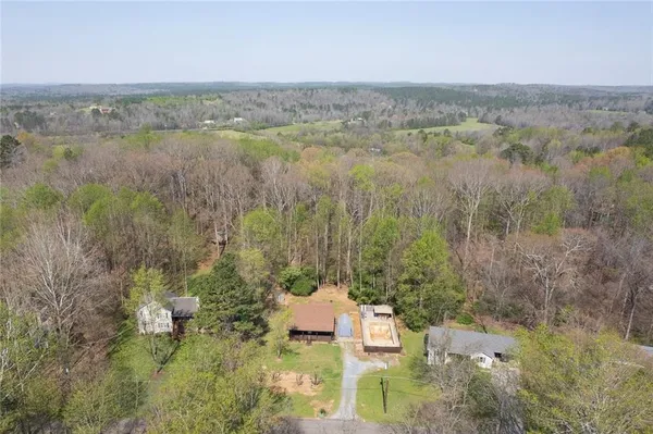 a aerial view of residential houses with outdoor space and trees
