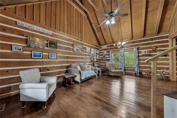 a living room with furniture and a chandelier