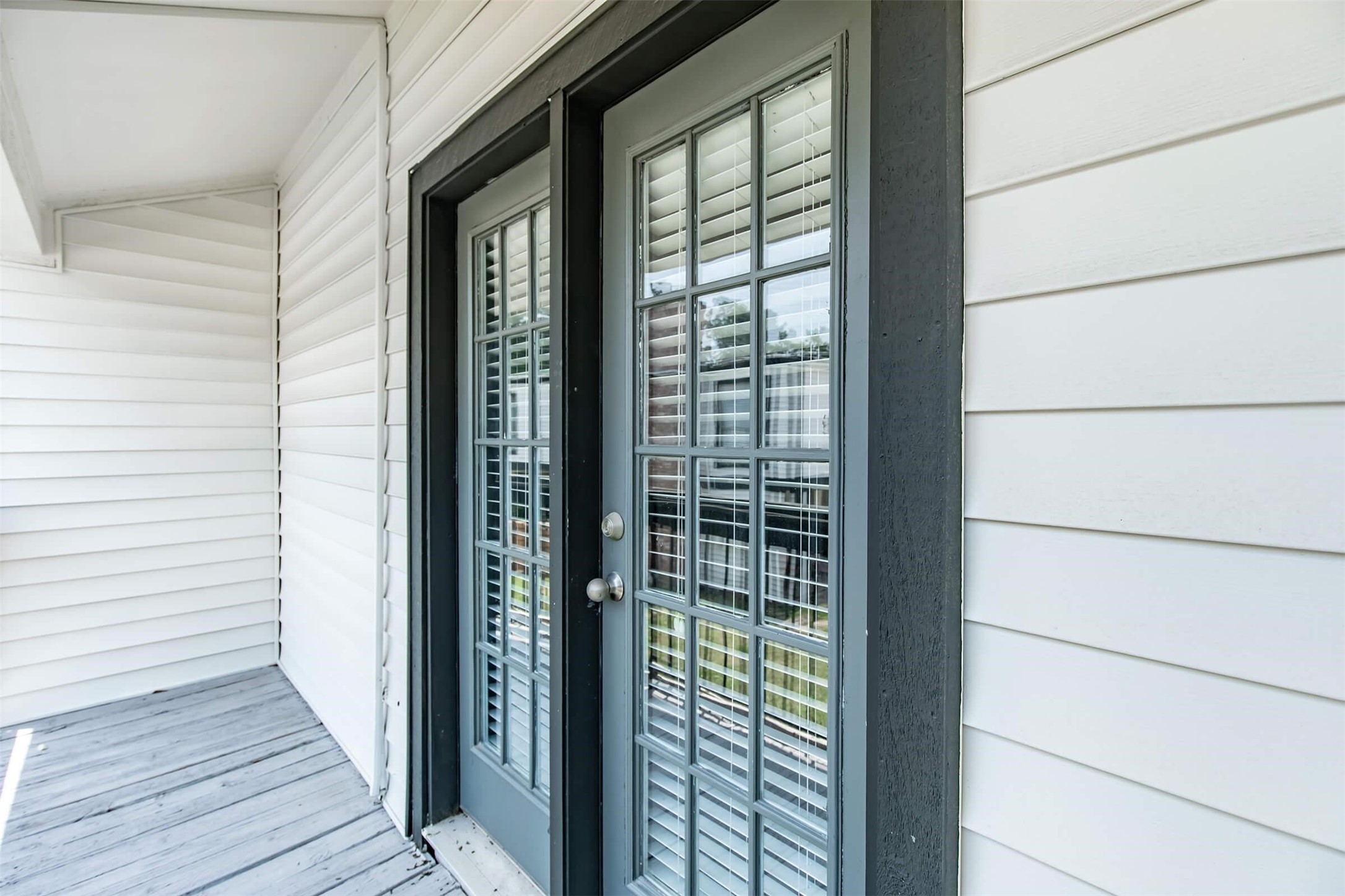 18001 Cypress Trace Road, Unit 803 Houston, TX 77090 - Photo 17 of 32 a view of a wooden balcony next to a yard