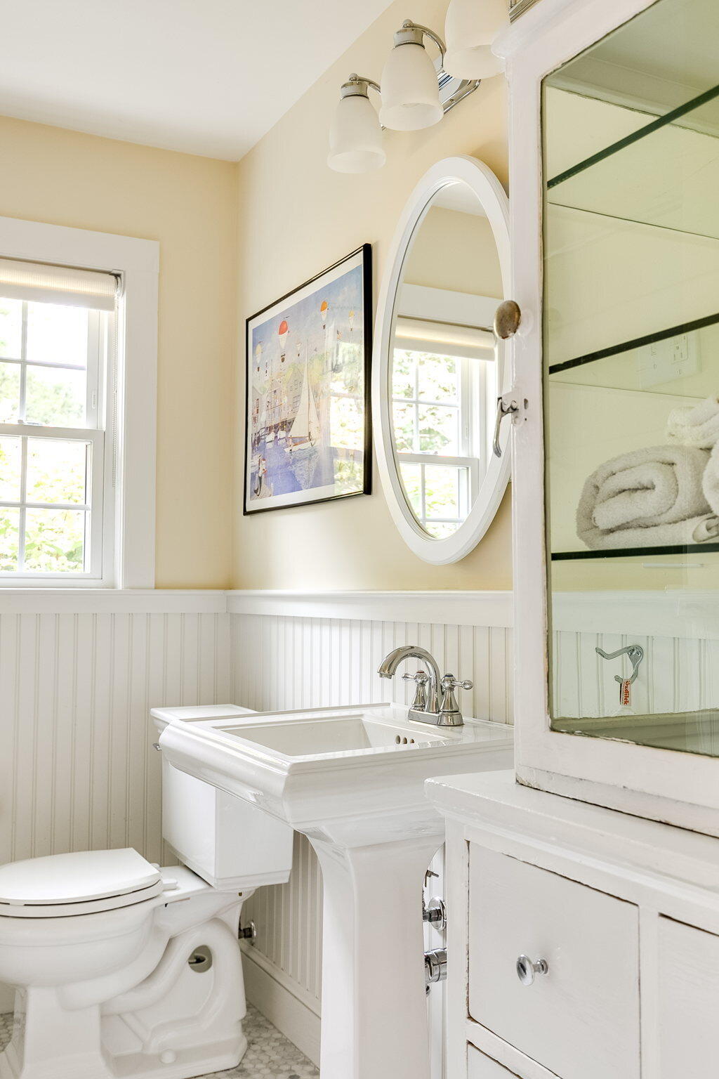311 Main Street Centerville, MA 02632 - Photo 30 of 45 a bathroom with a toilet a sink and mirror