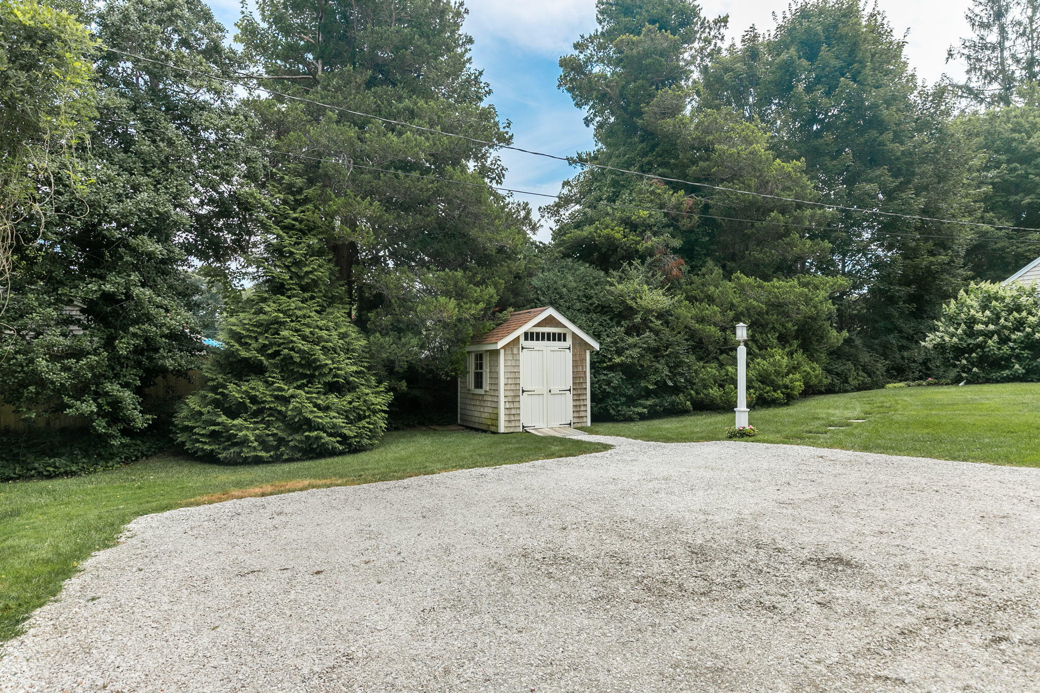 311 Main Street Centerville, MA 02632 - Photo 42 of 45 a view of a big yard with plants and large trees