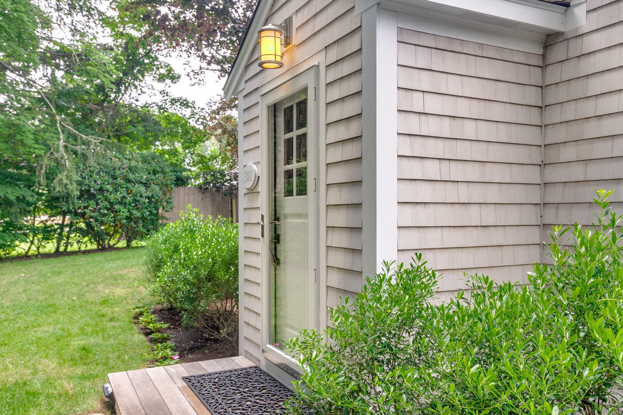 311 Main Street Centerville, MA 02632 - Photo 6 of 45 a view of a wooden door and a yard