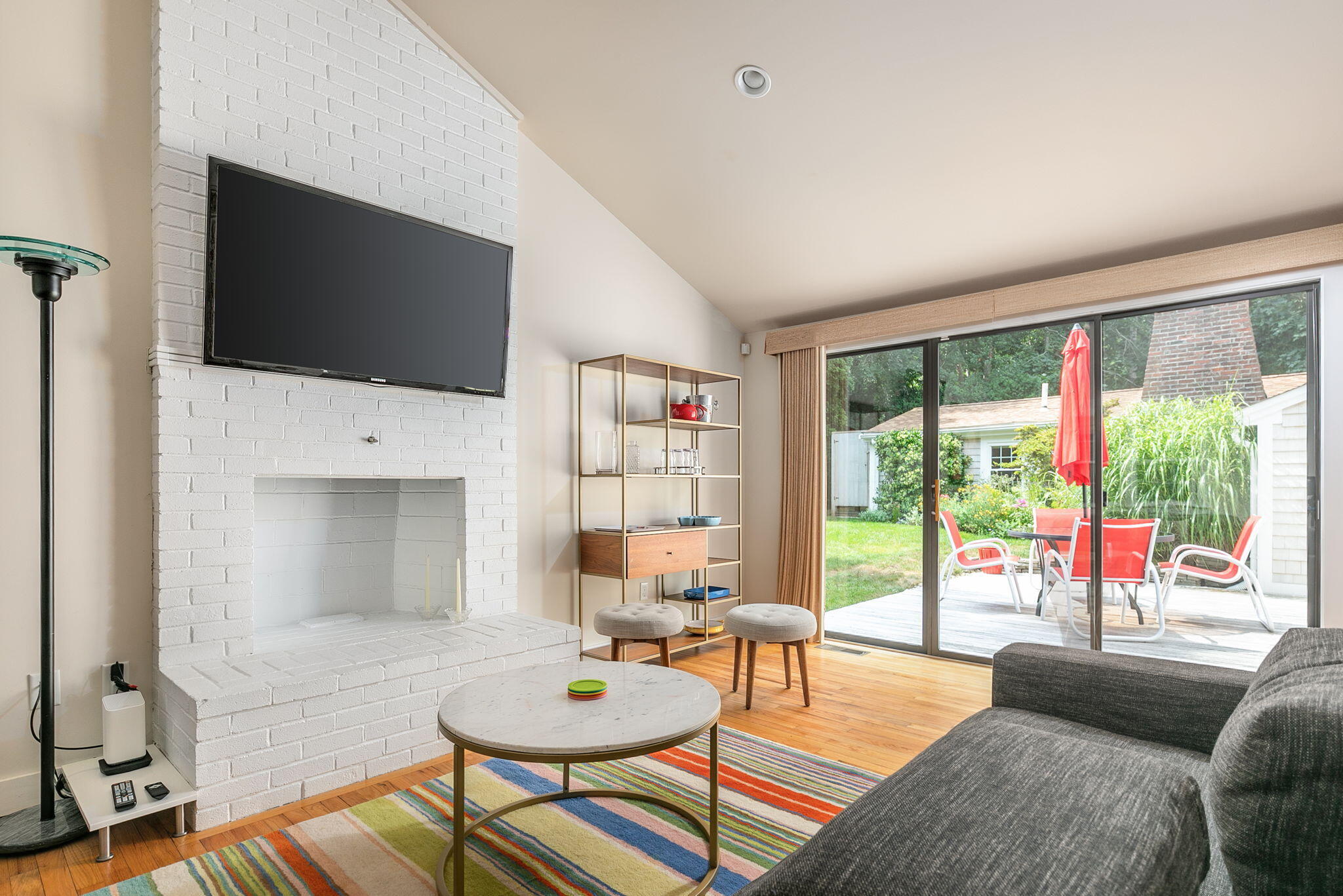 311 Main Street Centerville, MA 02632 - Photo 10 of 45 a living room with furniture a flat screen tv and a large window