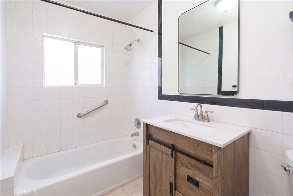 346 West School Street Compton, CA 90220 - Photo 20 of 29 a bathroom with a sink vanity tub and a mirror