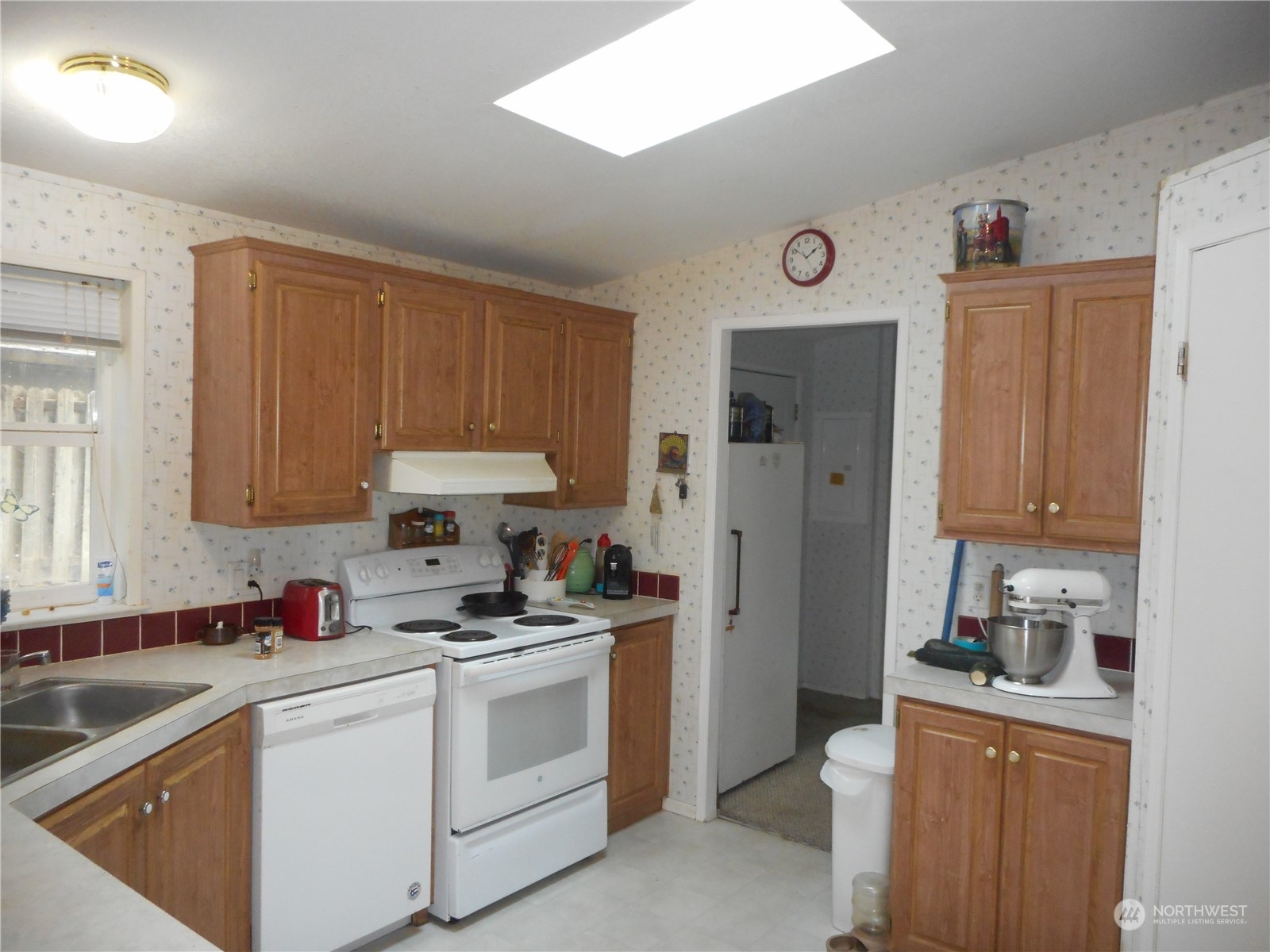 19817 Mac Road Granite Falls, WA 98252 - Photo 2 of 17 a kitchen with white cabinets and white appliances