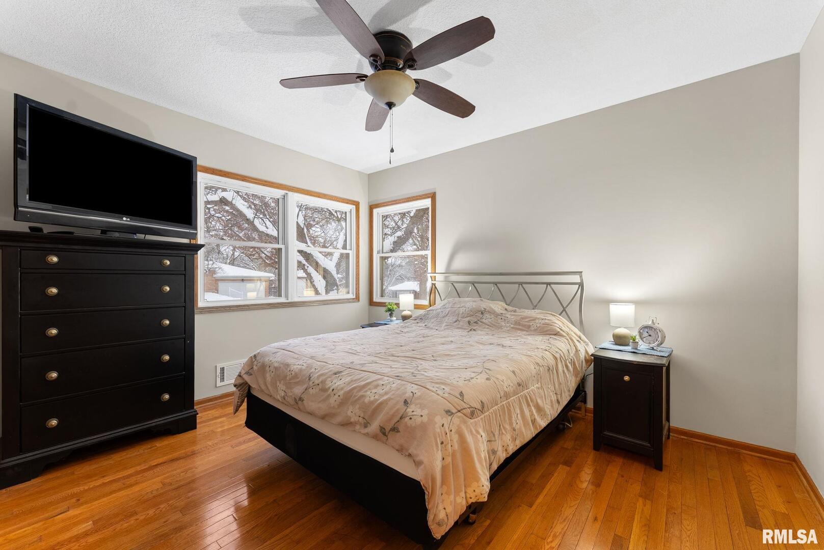 2530 37th Avenue Rock Island, IL 61201 - Photo 16 of 31 a bedroom with a bed and a flat tv screen on dresser