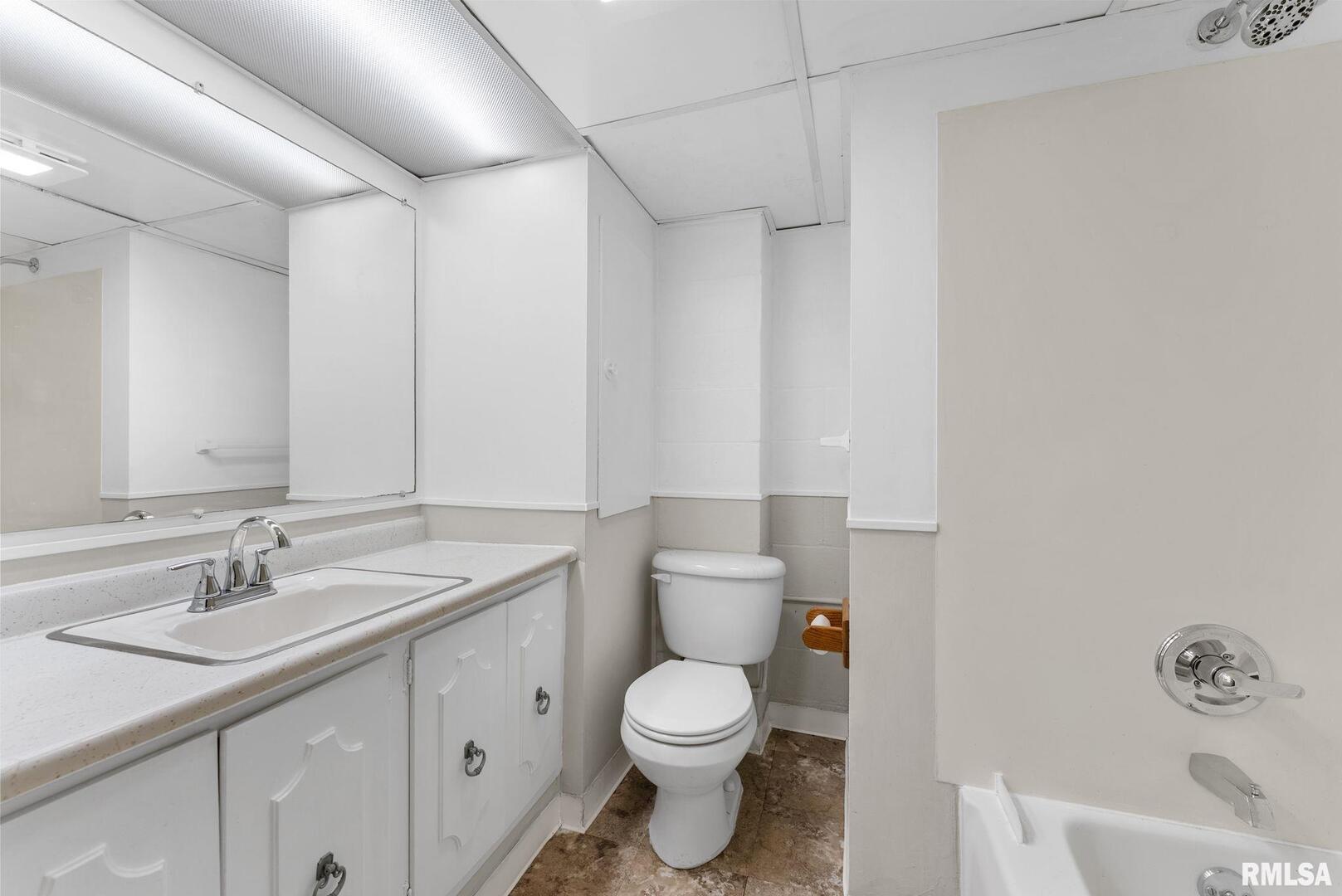 2530 37th Avenue Rock Island, IL 61201 - Photo 24 of 31 a bathroom with a toilet a sink a mirror and a shower