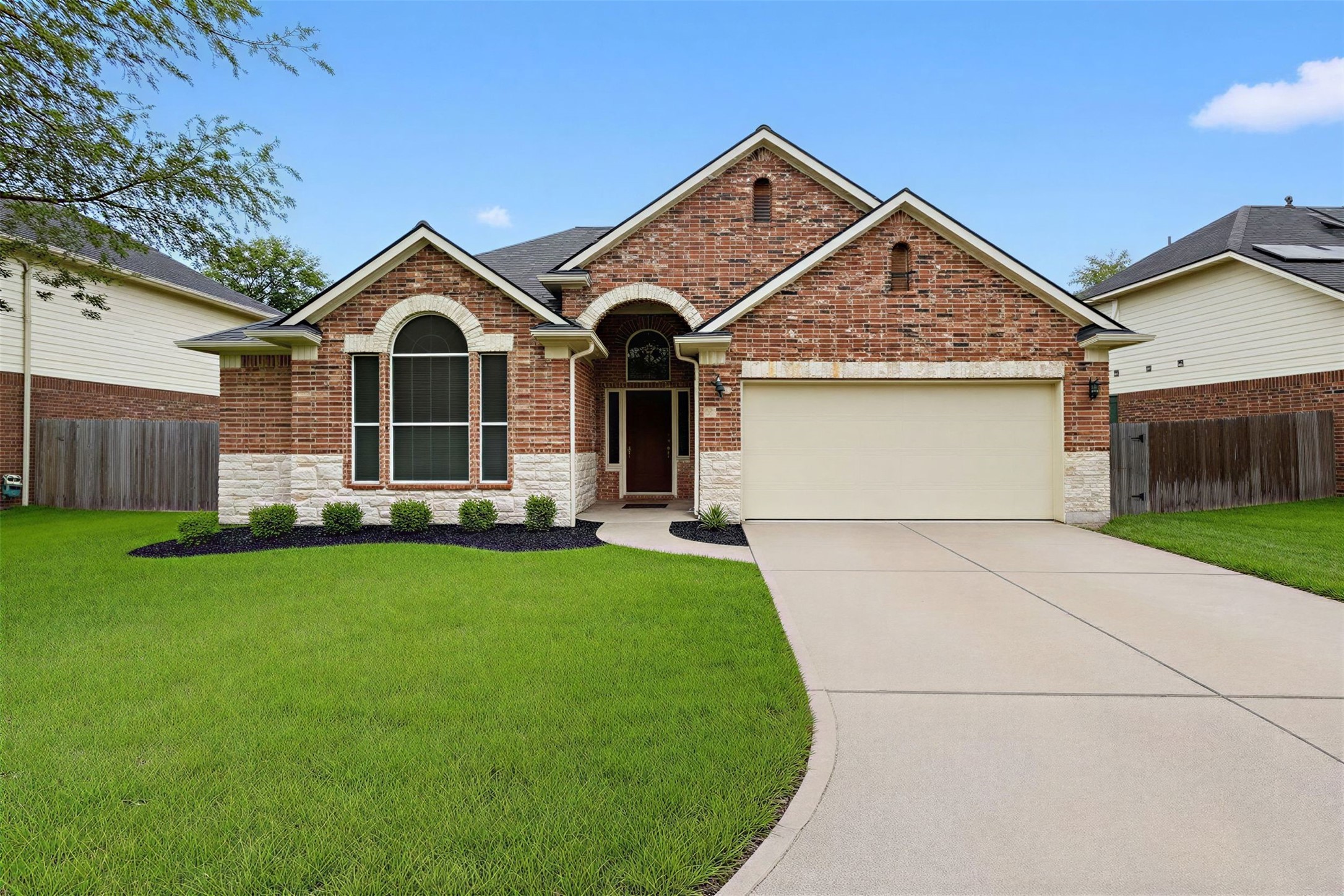 Front Exterior (Enhanced Landscaping View)
Beautifully maintained front elevation featuring fresh landscaping, arched architectural details, and a