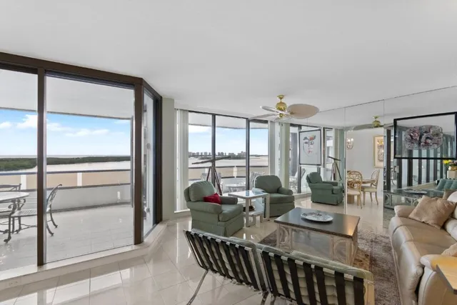 a view of a livingroom with furniture and floor to ceiling window
