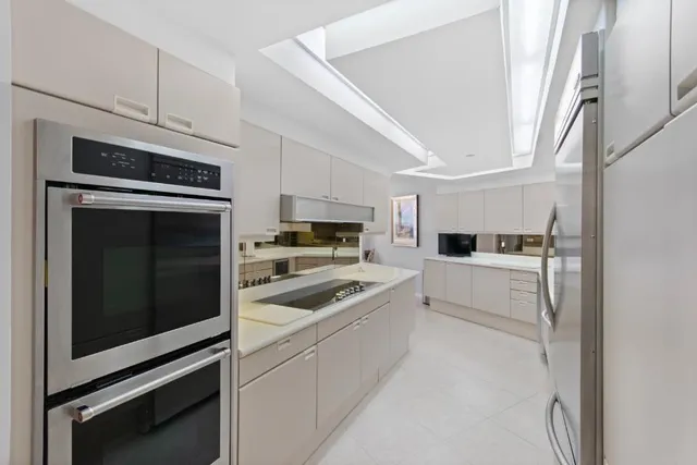 a kitchen with cabinets stainless steel appliances and counter space