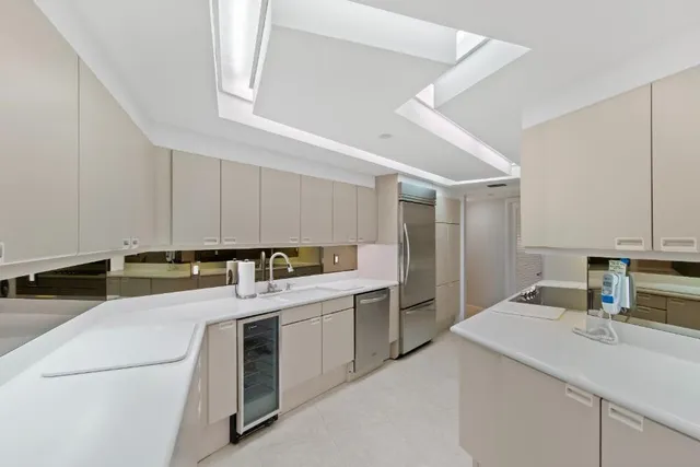 a kitchen that has a sink and a stove in it