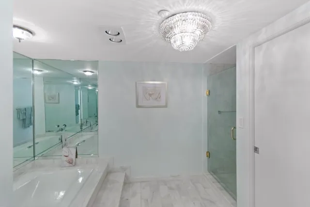 a bathroom with a shower a mirror and a sink