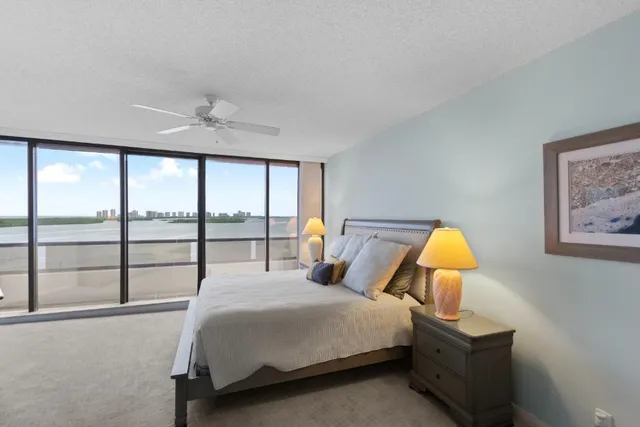 a bedroom with a bed and a large window