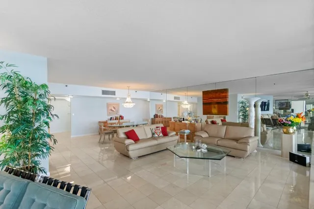 a living room with furniture and flowers