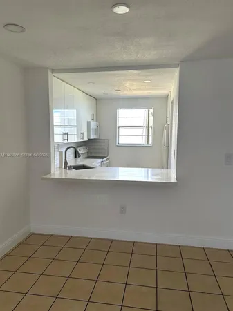 a kitchen with a sink cabinets and window