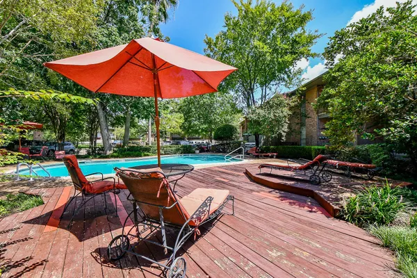 a living room with furniture wooden floor and a large window