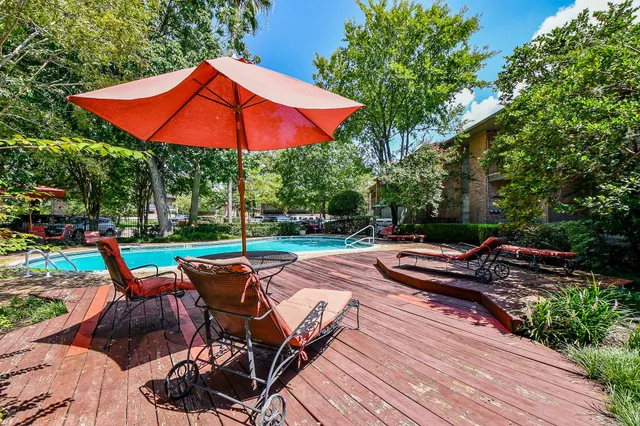 a living room with furniture wooden floor and a large window