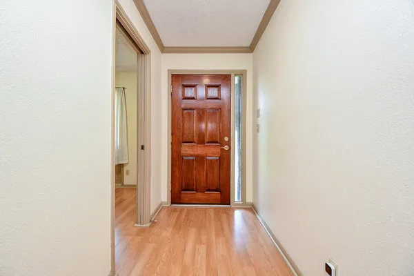 a view of a hallway with wooden floor