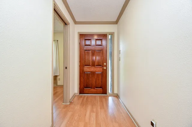 a view of a hallway with wooden floor