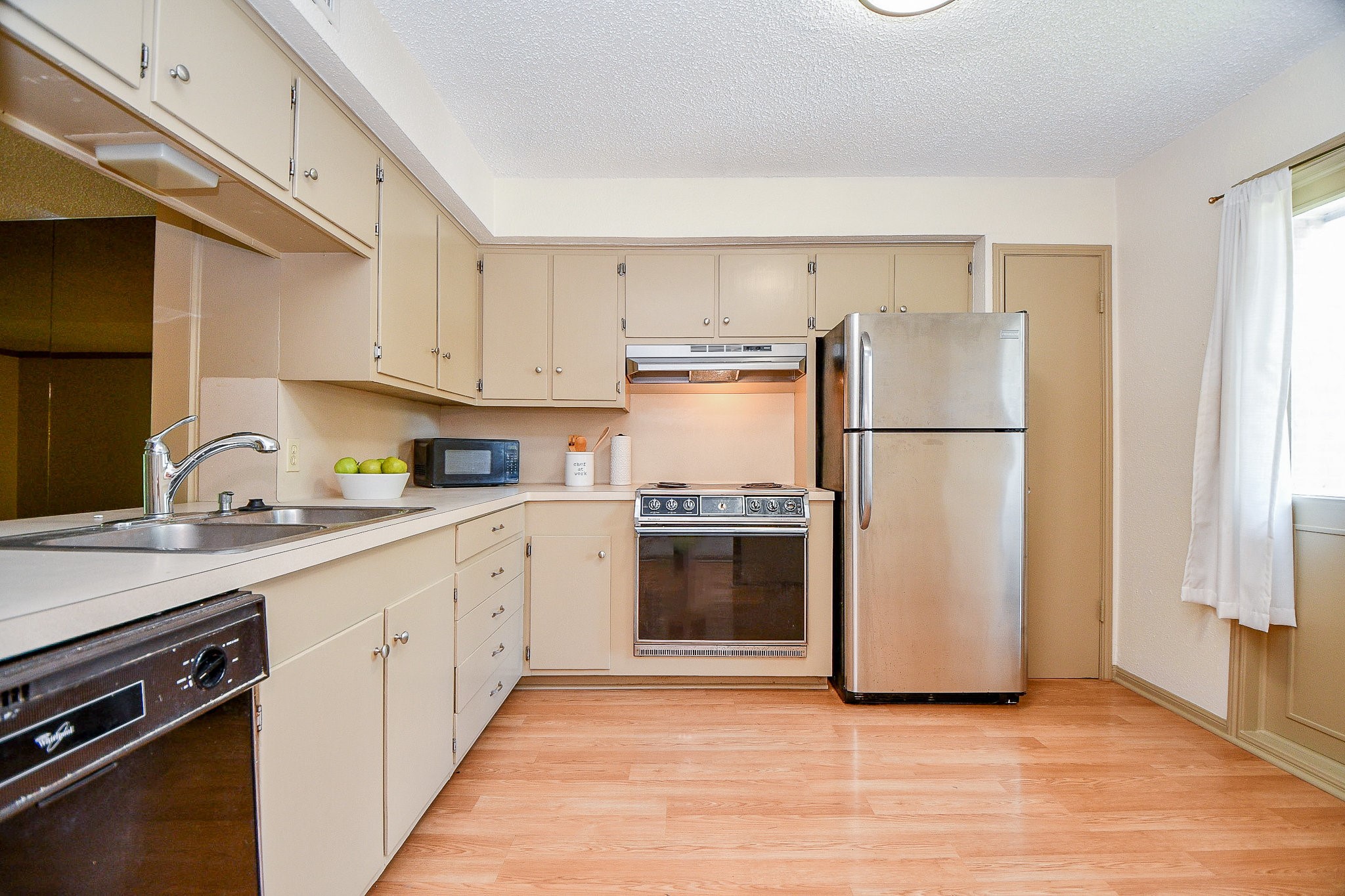 6533 Bayou Glen Road Houston, TX 77057 - Photo 3 of 19 a kitchen with a refrigerator sink and cabinets