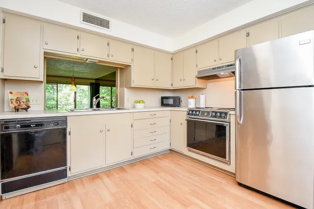 a kitchen with a white cabinets and white appliances