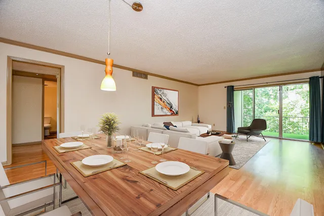 a room with furniture a large window and dining table