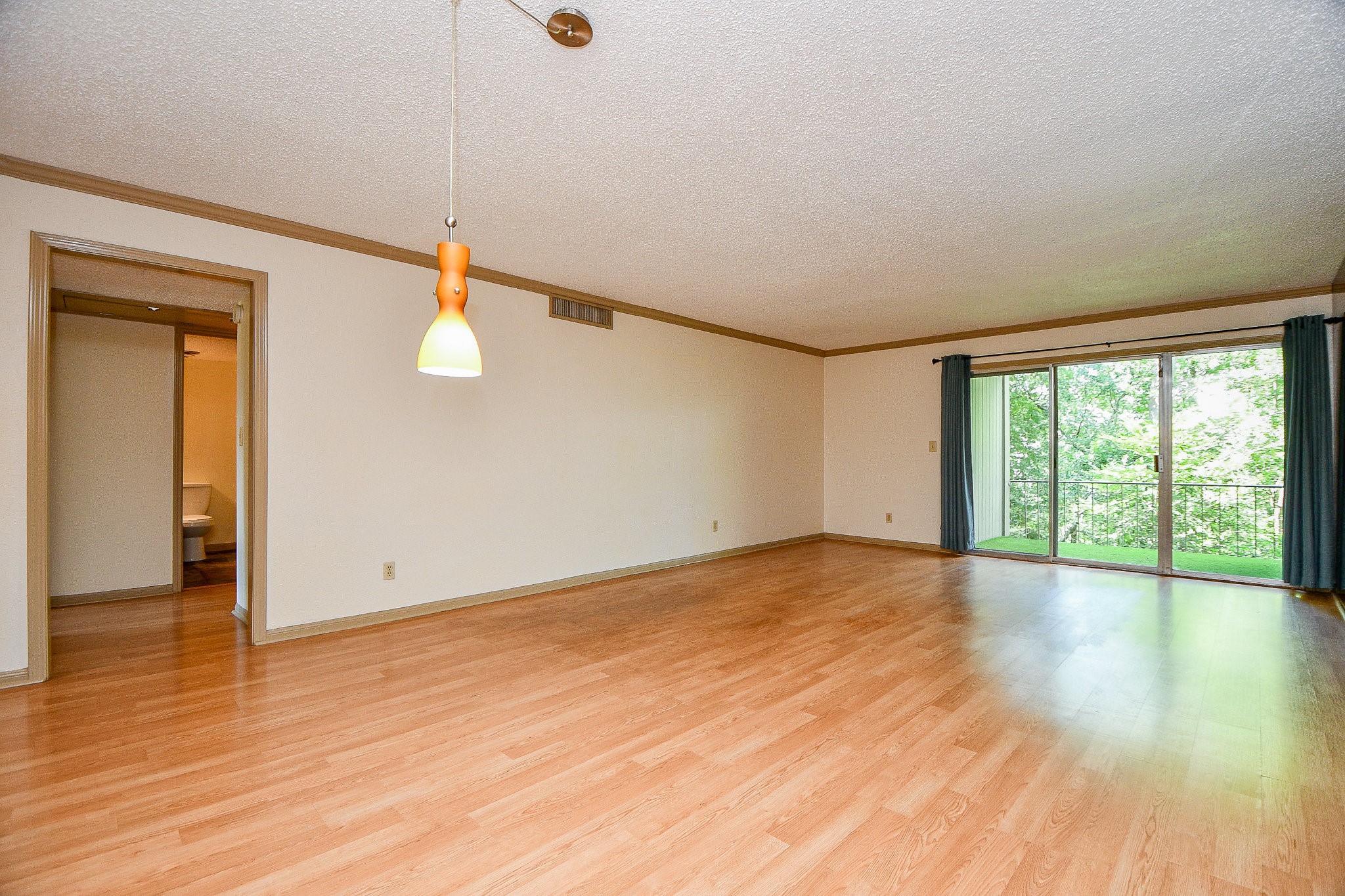 6533 Bayou Glen Road Houston, TX 77057 - Photo 8 of 19 an empty room with wooden floor and windows