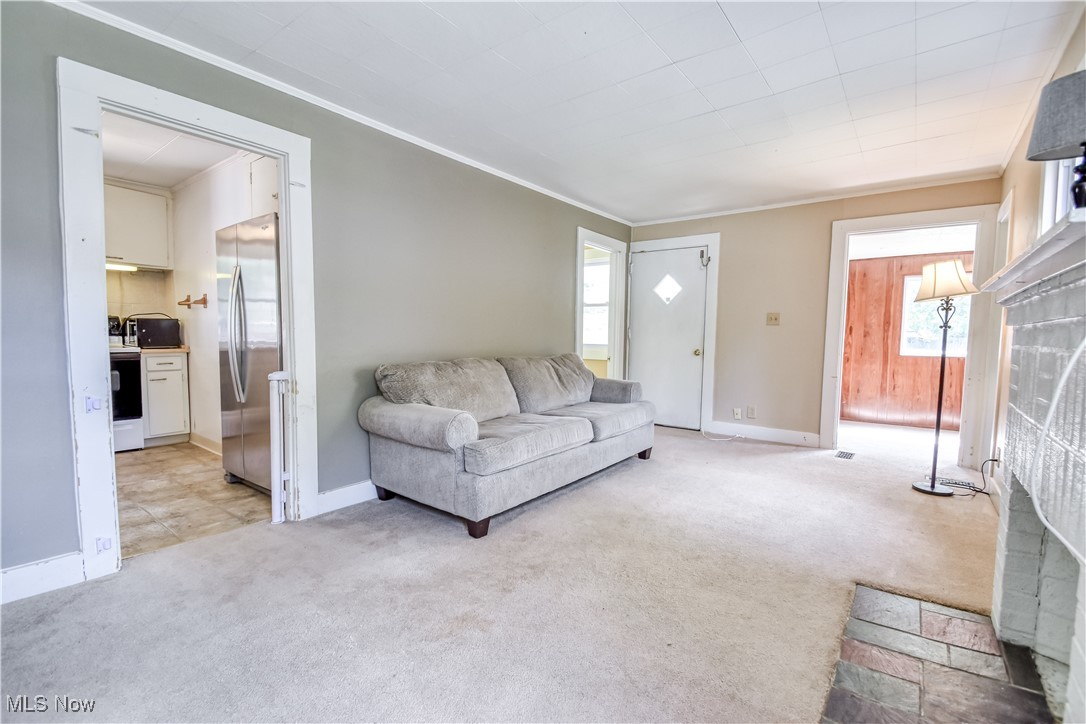 7665 Miami Road Mentor, OH 44060 - Photo 4 of 20 Living room featuring light colored carpet and ornamental molding