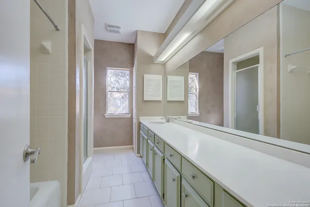 a bathroom with a sink a vanity and a mirror