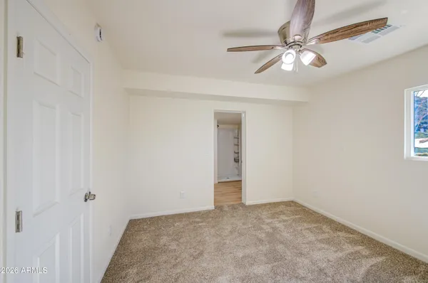a view of a room with a ceiling fan