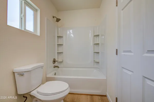 a bathroom with a toilet and a bathtub