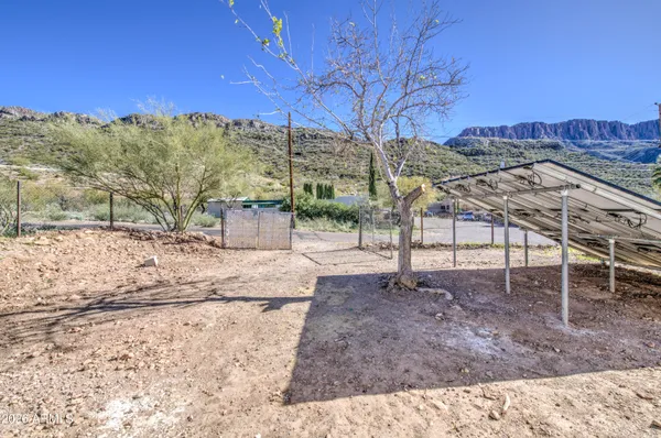 a view of a backyard with wooden fence