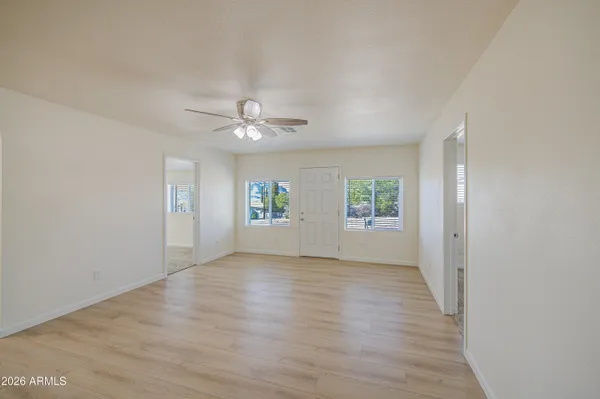 wooden floor in an empty room with a window