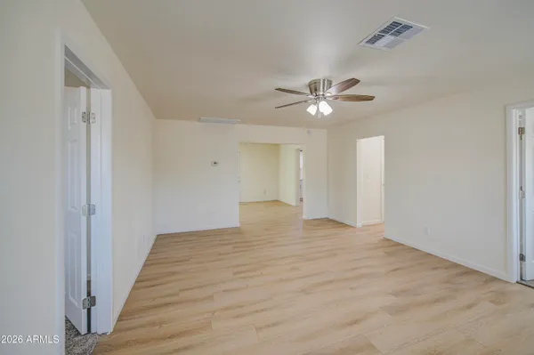 a view of an empty room with a ceiling fan