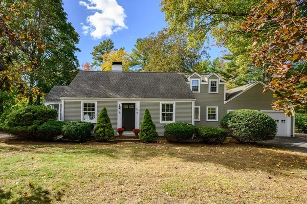 a front view of house with yard and green space