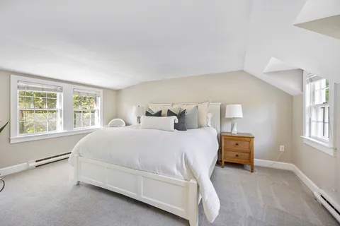 a spacious bedroom with a bed and a window