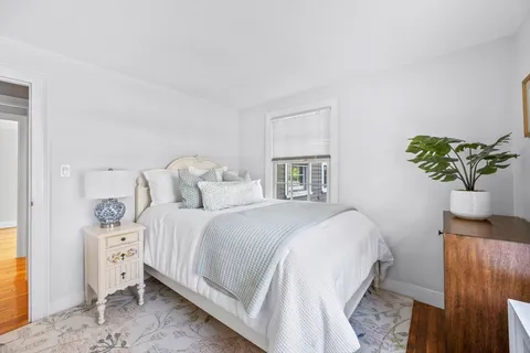 a bedroom with bed and window