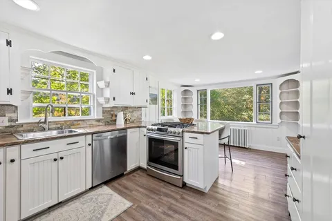 a kitchen with stainless steel appliances granite countertop a stove and a sink