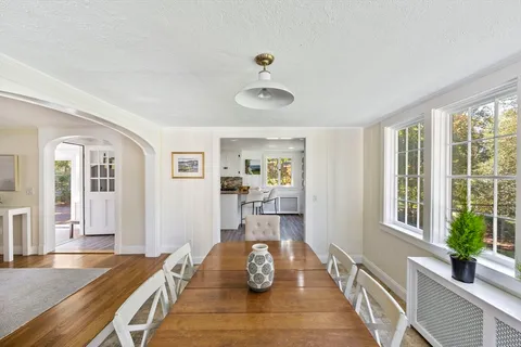 a bedroom with furniture and a large window