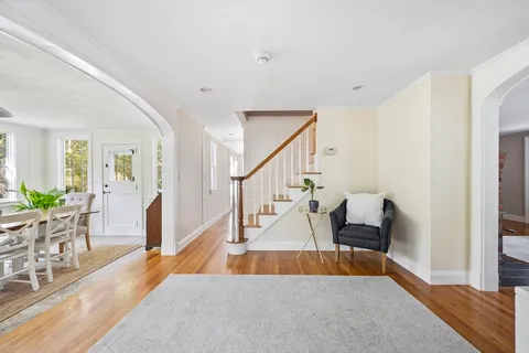 a view of entryway and hall with wooden floor