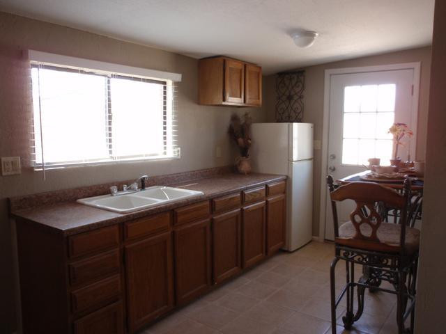 420 East Garfield Street Tempe, AZ 85288 - Photo 5 of 7 a kitchen with stainless steel appliances granite countertop a refrigerator sink and white cabinets