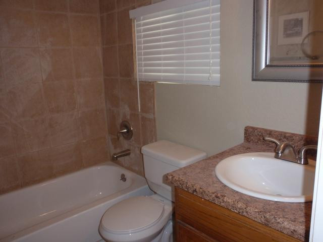 420 East Garfield Street Tempe, AZ 85288 - Photo 6 of 7 a bathroom with a granite countertop sink a toilet and bathtub