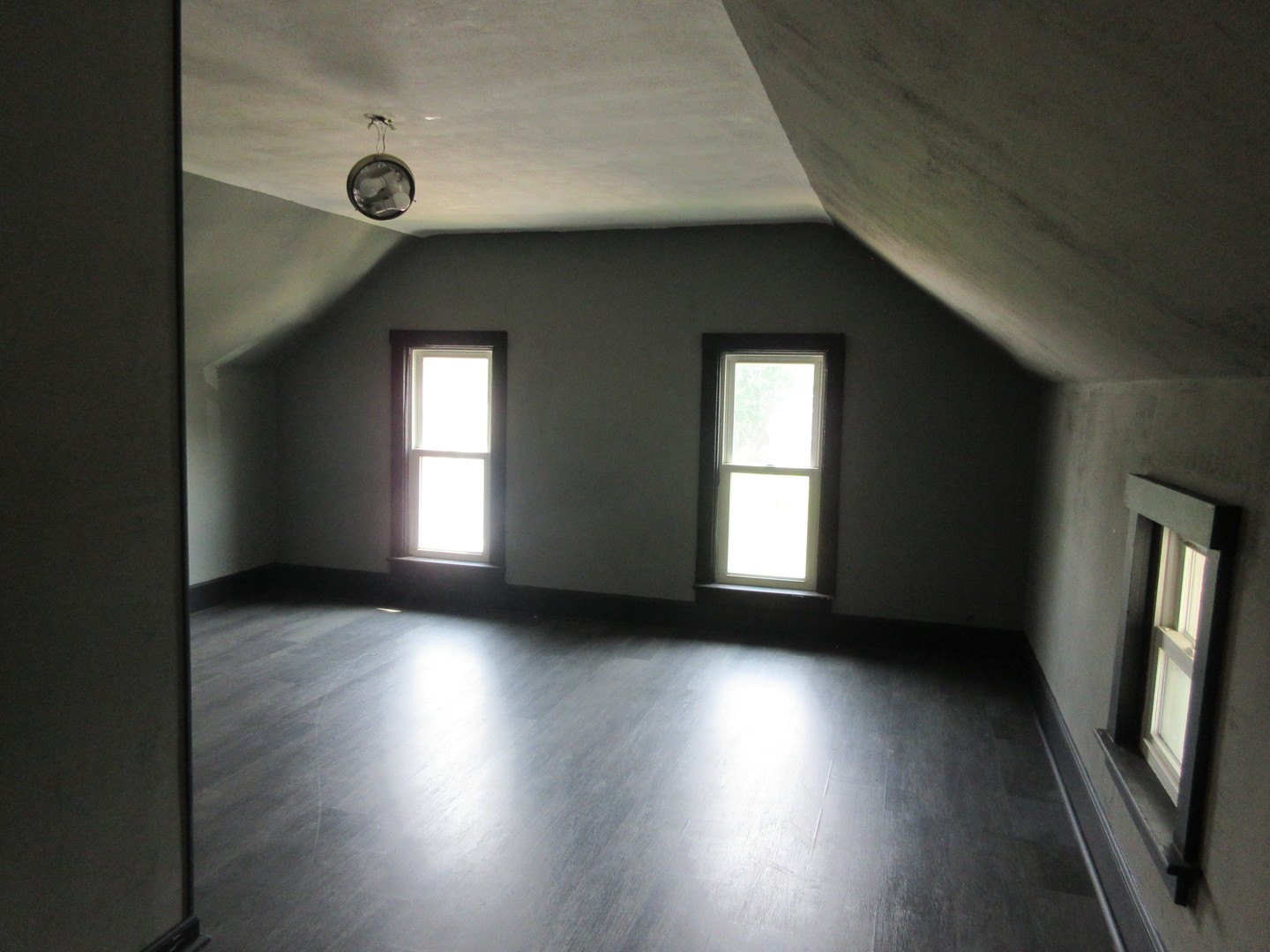 308 West Grove Road Sterling, IL 61081 - Photo 13 of 35 a view of an empty room with wooden floor and a window