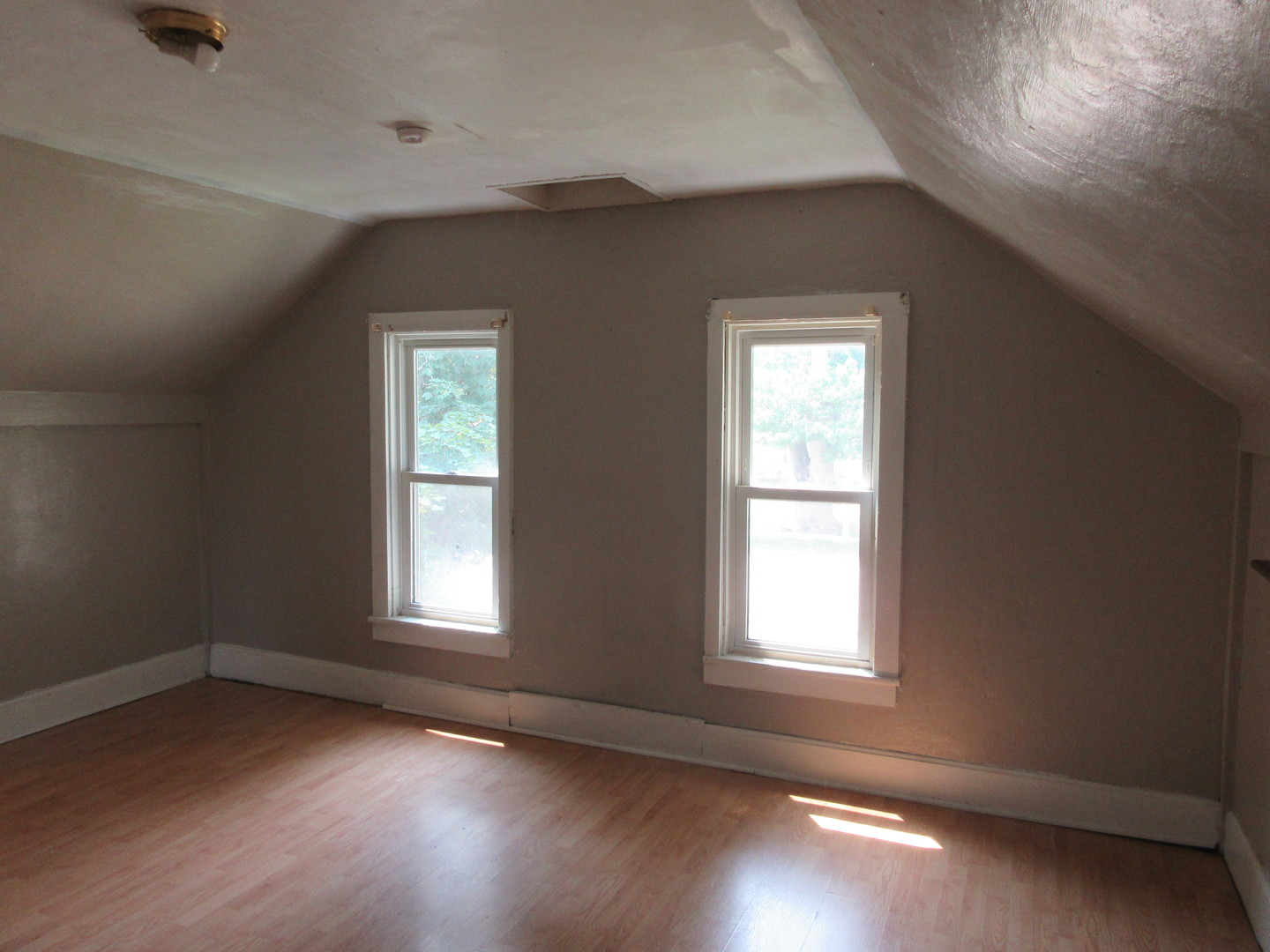308 West Grove Road Sterling, IL 61081 - Photo 16 of 35 an empty room with wooden floor and windows