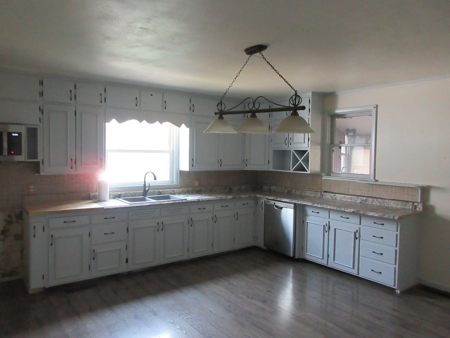 308 West Grove Road Sterling, IL 61081 - Photo 6 of 35 a kitchen with stainless steel appliances granite countertop a sink a stove and wooden floors