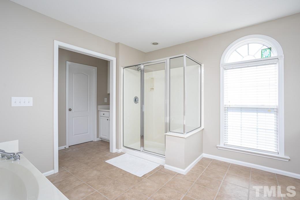8206 Marvino Lane Raleigh, NC 27613 - Photo 14 of 30 This large Master bathroom has all you need to prepare for your day. Or relax in the garden tub as you unwind!