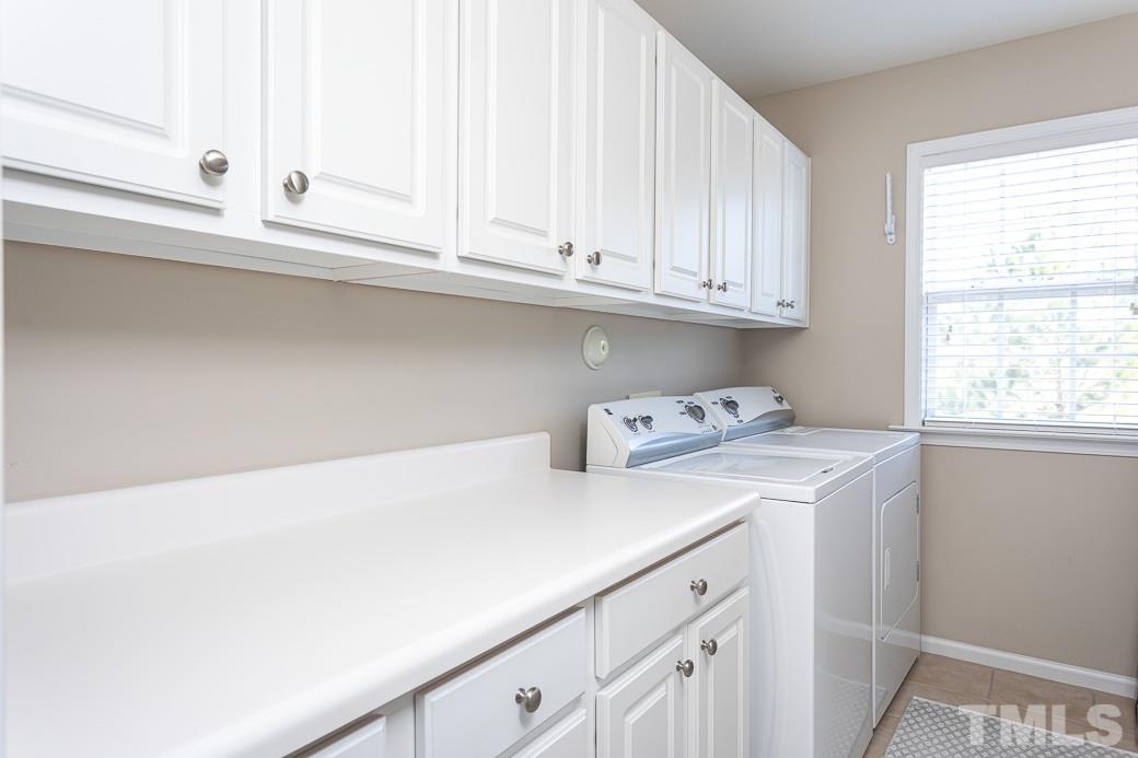 8206 Marvino Lane Raleigh, NC 27613 - Photo 22 of 30 Second floor laundry room has ample storage space for your washing/utility needs. Counters allow for easy folding!
