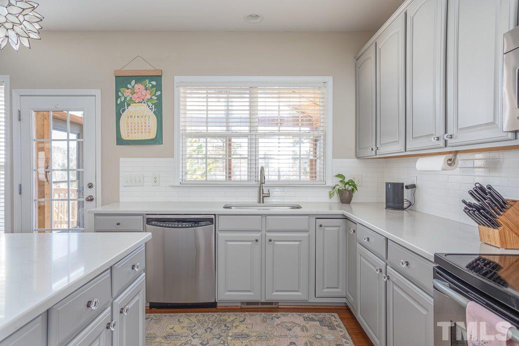 8206 Marvino Lane Raleigh, NC 27613 - Photo 8 of 30 The subway tile backsplash neatly coordinates with the beautiful quartz counters!
